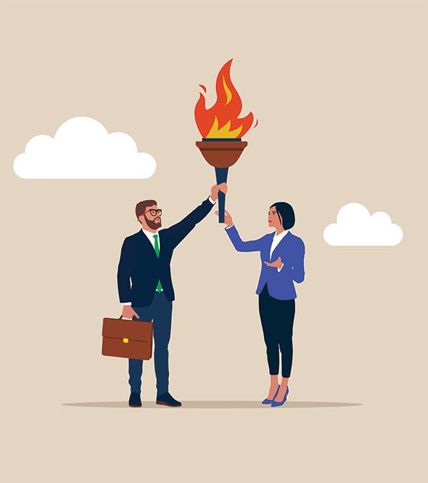 A man and woman holding up a torch